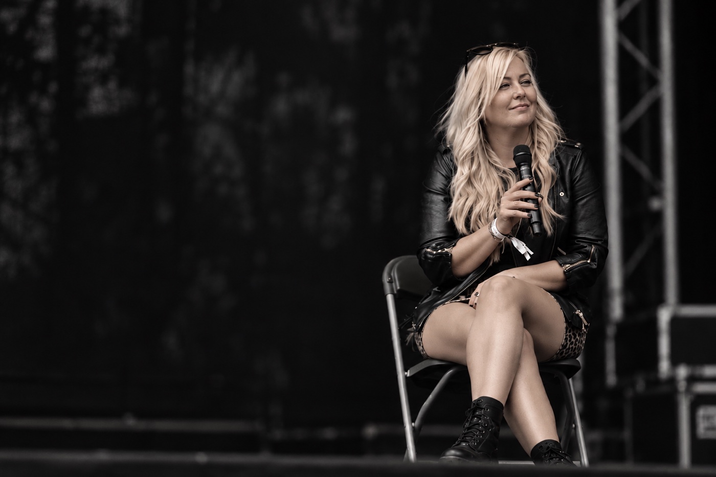 Charlotte on stage holding a microphone